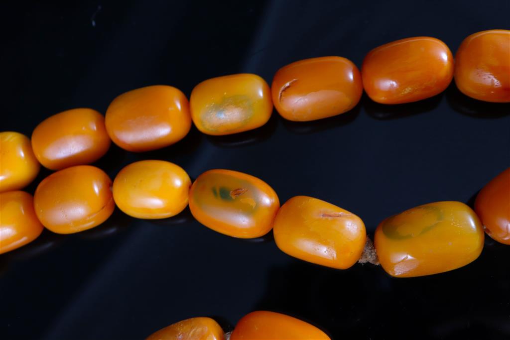 A single strand oval amber bead necklace, 74cm, gross weight 128 grams,